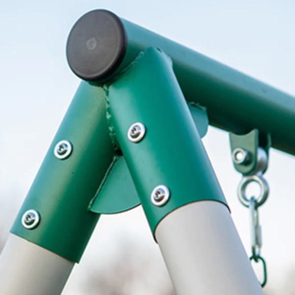 The top left corner of a heavy-duty metal swing set