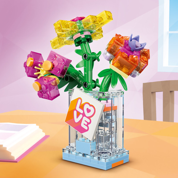 Holds a bouquet of colorful brick-built flowers.