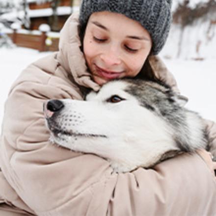 Woman hugging husky dog