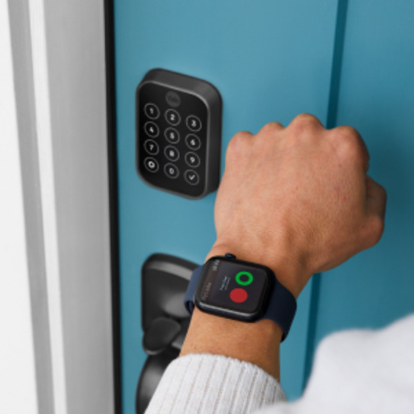 Man unlocking door lock with key
