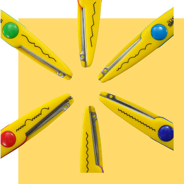 Close-up showing multiple decorative scissor blade patterns for creating unique paper edges.
