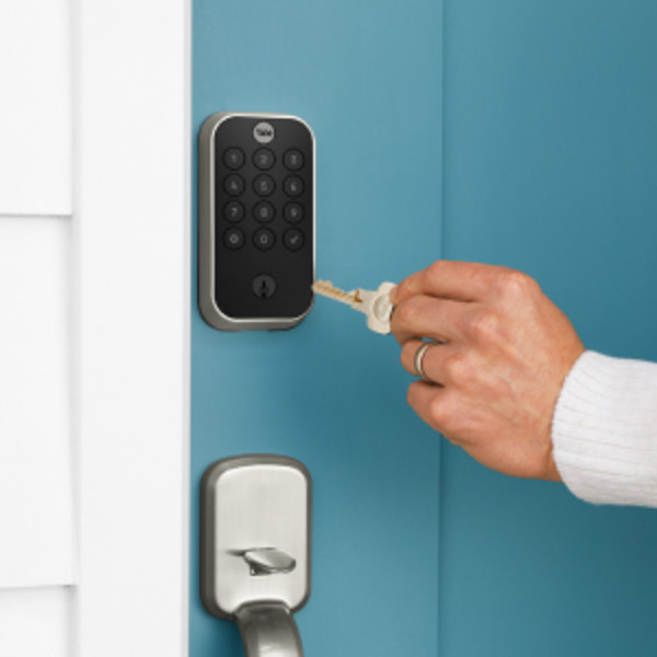 Man unlocking door lock with key