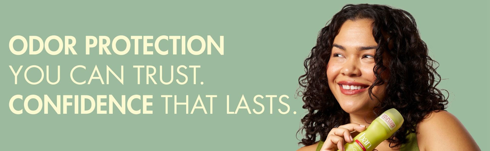 Woman holding a bottle of Ban deodorant.