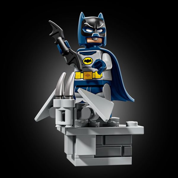 The figure wears his cape and cowl and holds a Batarang .