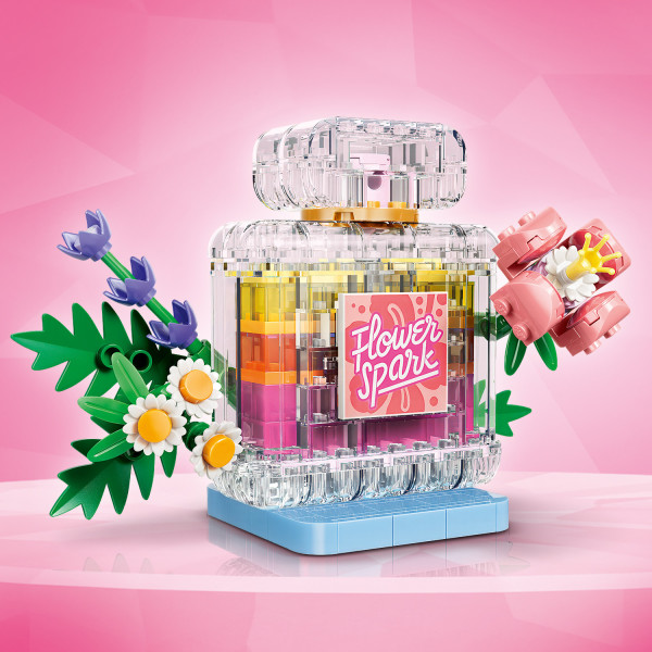 Model with pressable nozzle sits on a stand with flowers.