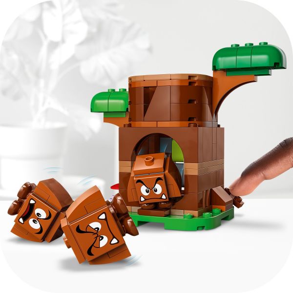 Press the lever to make a Goomba pop out of the tree trunk.