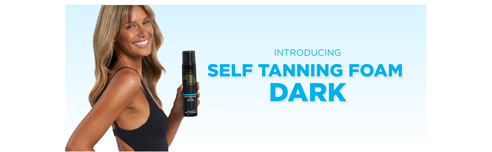 Woman holding a bottle of Dark Bondi Sands Self Tanner.
