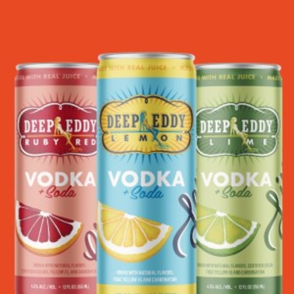 Deep Eddy Vodka + Soda Hard Seltzers cans on red background.