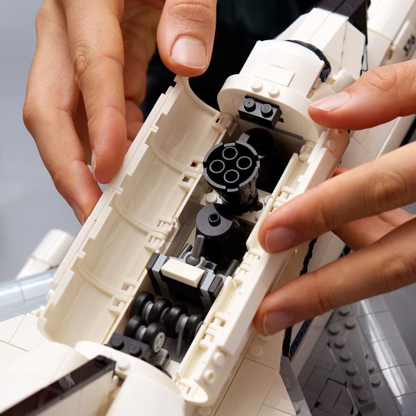Store the shuttle engines and landing gear in its cargo bay.