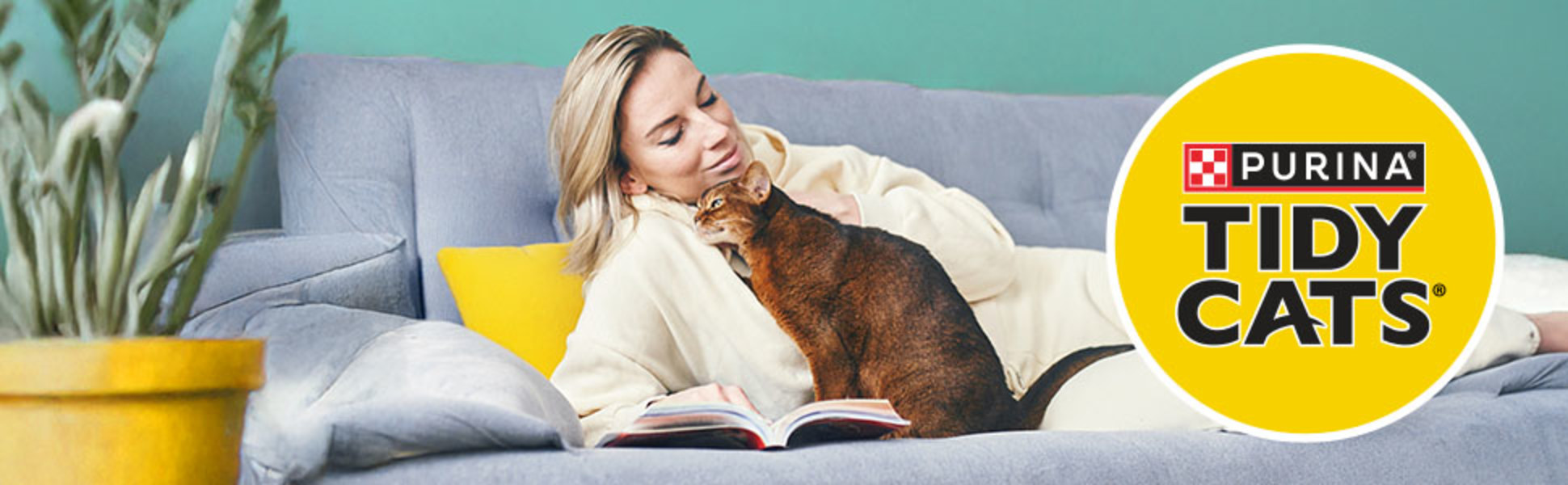 A woman and her cat resting comfortably on a living room couch.