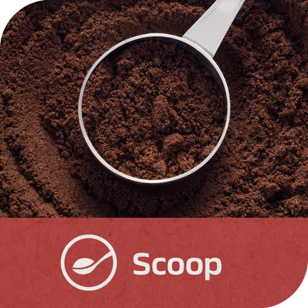 A measuring scoop filled with instant coffee grounds above more coffee grounds. Tagline: Scoop.