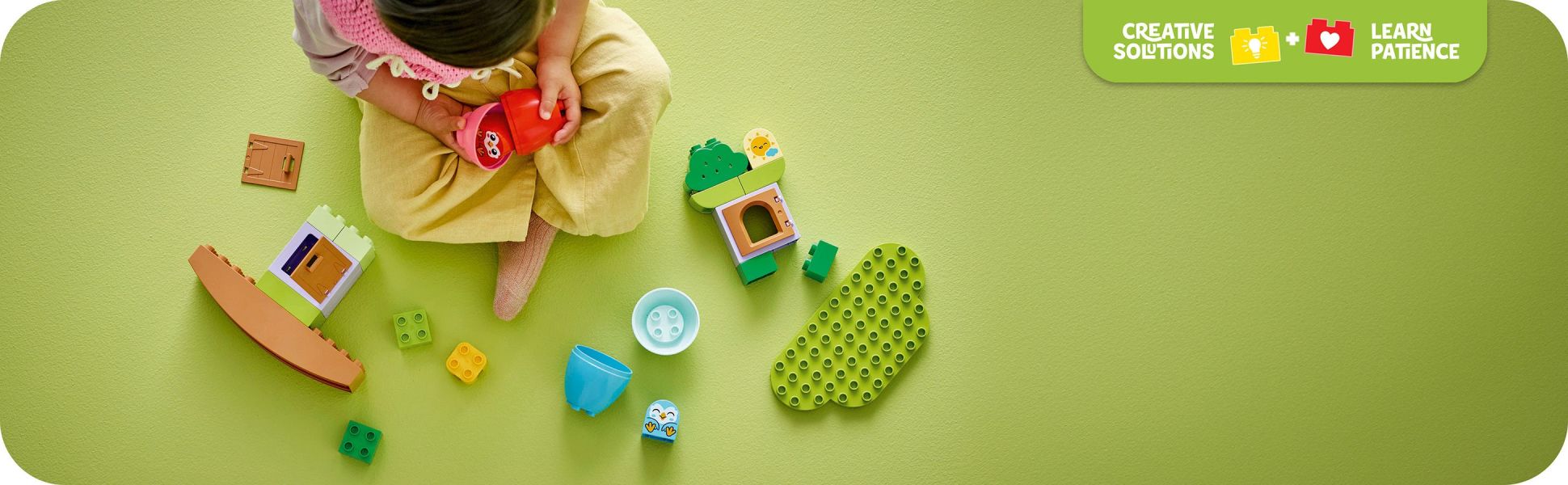 Toddlers use their creativity and perseverance to build and rebuild their tree house toy.