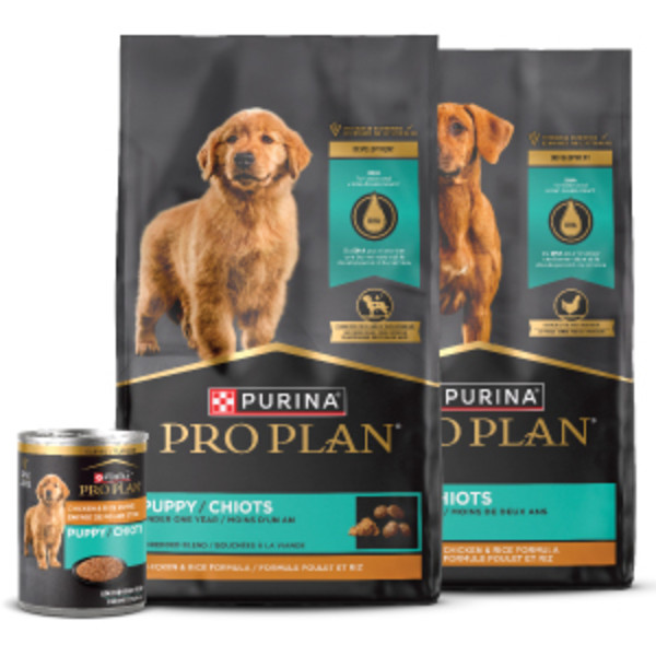 Two bags of Pro Plan dry puppy food with one can of wet puppy food