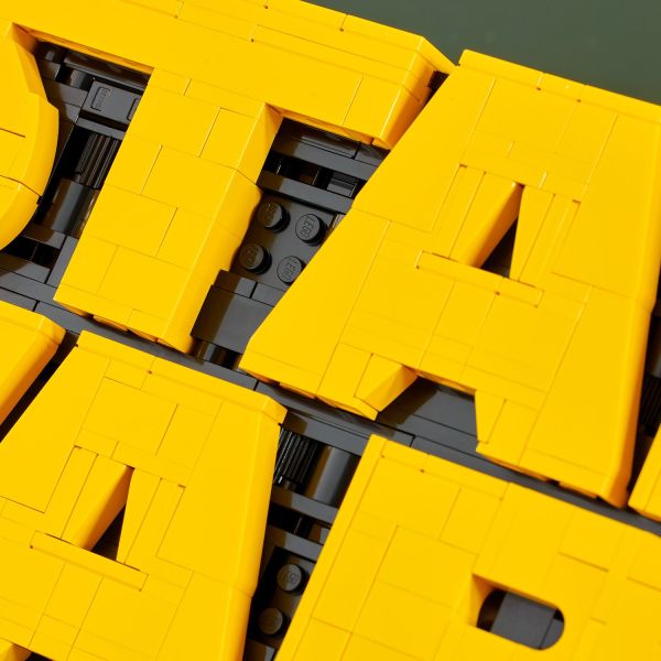 Apply classic LEGO greebling details between the letters.