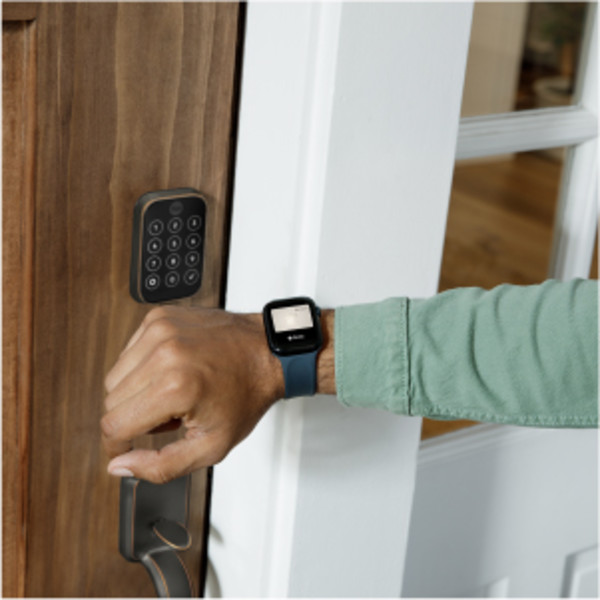 Man unlocking door lock with key