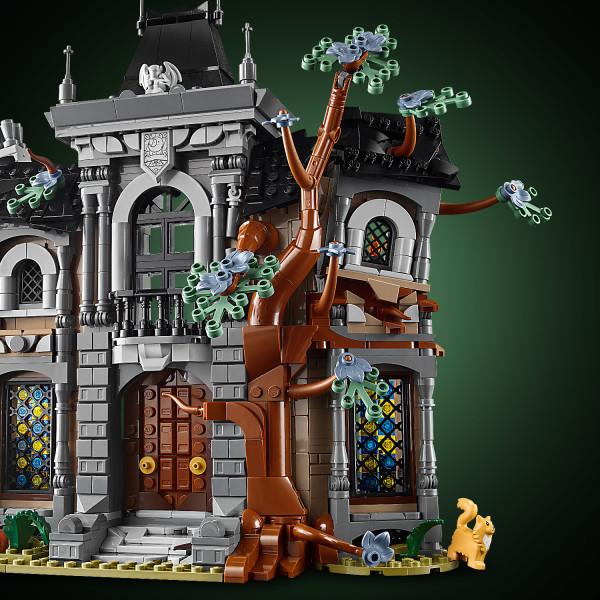 An old tree nestles comfortably into the manor’s twisted facade.
