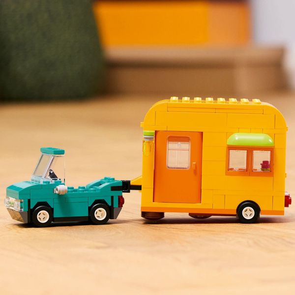 Attach the caravan toy to the car.