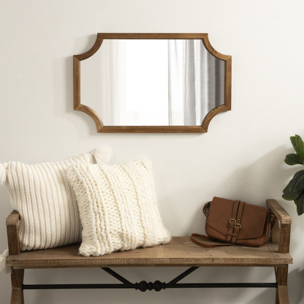 brown wooden mirror over bench in entryway