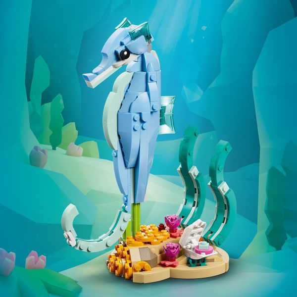 Sea creature is on a stand with seaweed and a posable clam.