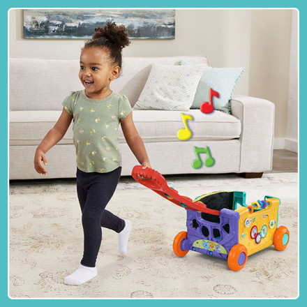 Kid pulls wagon with easy to grip red handle. Wagon plays music while in motion.