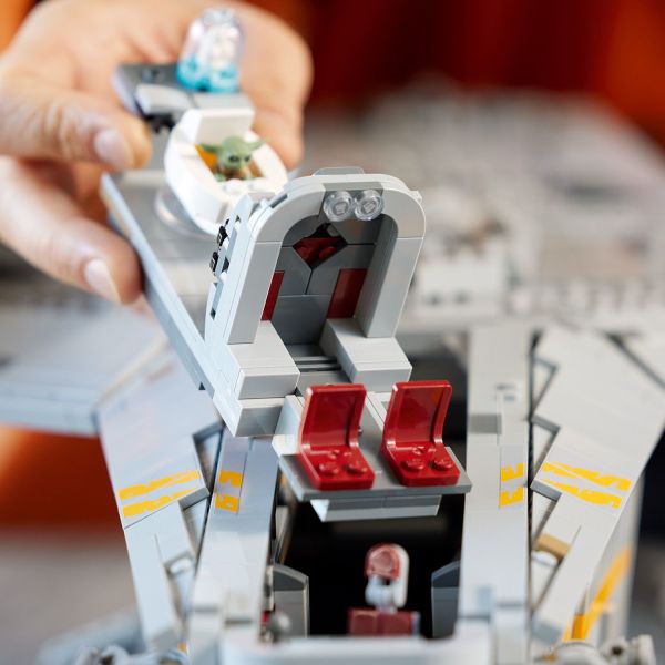 Place Grogu in his pram in the cockpit.