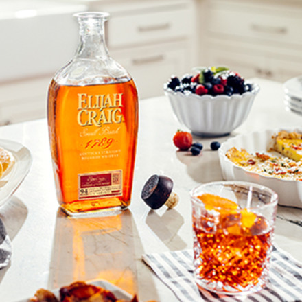 Elijah Craig small batch on a sunny kicthen counter. Right, Boulevardier in rocks glass.