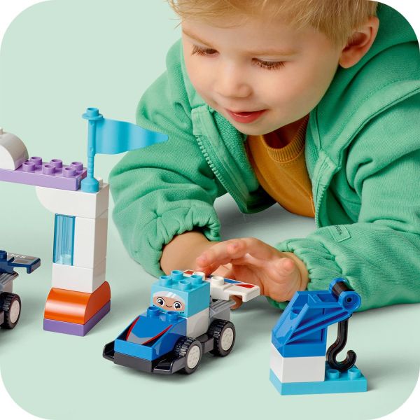 Little mechanics inspect the cars using the crane toy.