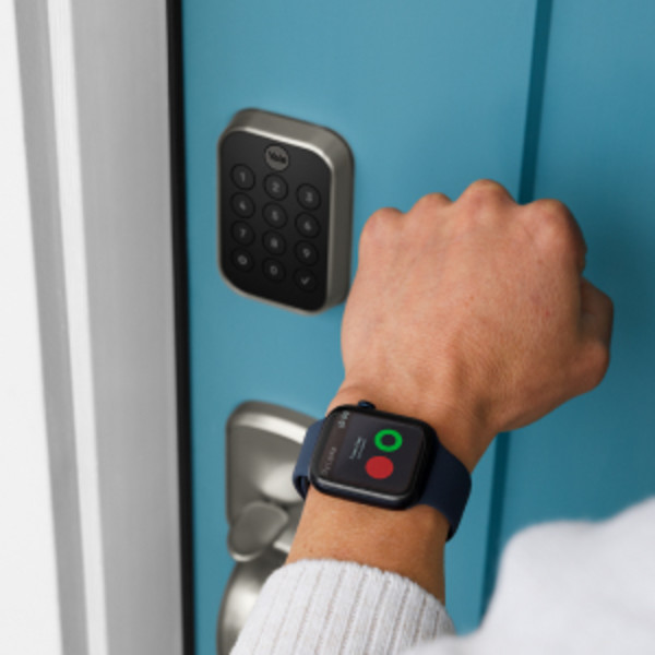 Man unlocking door lock with key