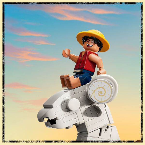 Luffy sits on the sheep figurehead above the ship’s cannon.