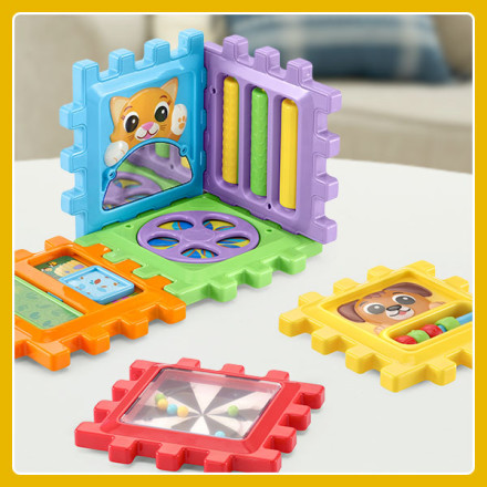 Pieces of the 6-in-1 Snap & Learn Busy Cube shown to display colorful pieces and characters.
