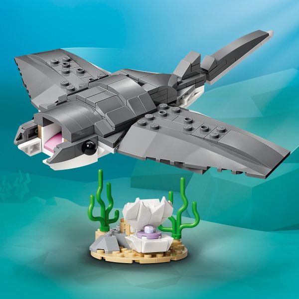 Posable manta ray toy has a movable tail fin.