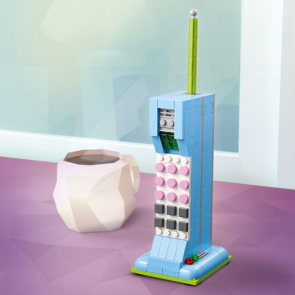Phone features large buttons and sits on a charging base.