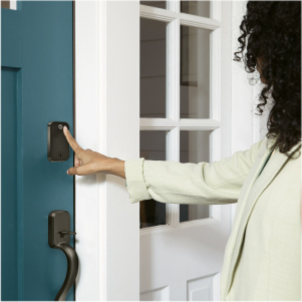 Man unlocking door lock with key