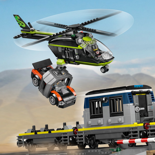 Use the helicopter’s claw to grab items from the train.