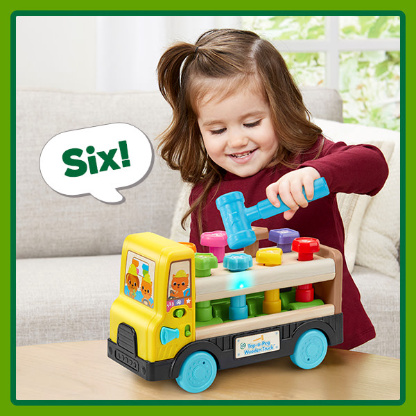 Girl uses a toy hammer to tap the number 6, plastic nail into the truck. Truck glows blue & says: 6!