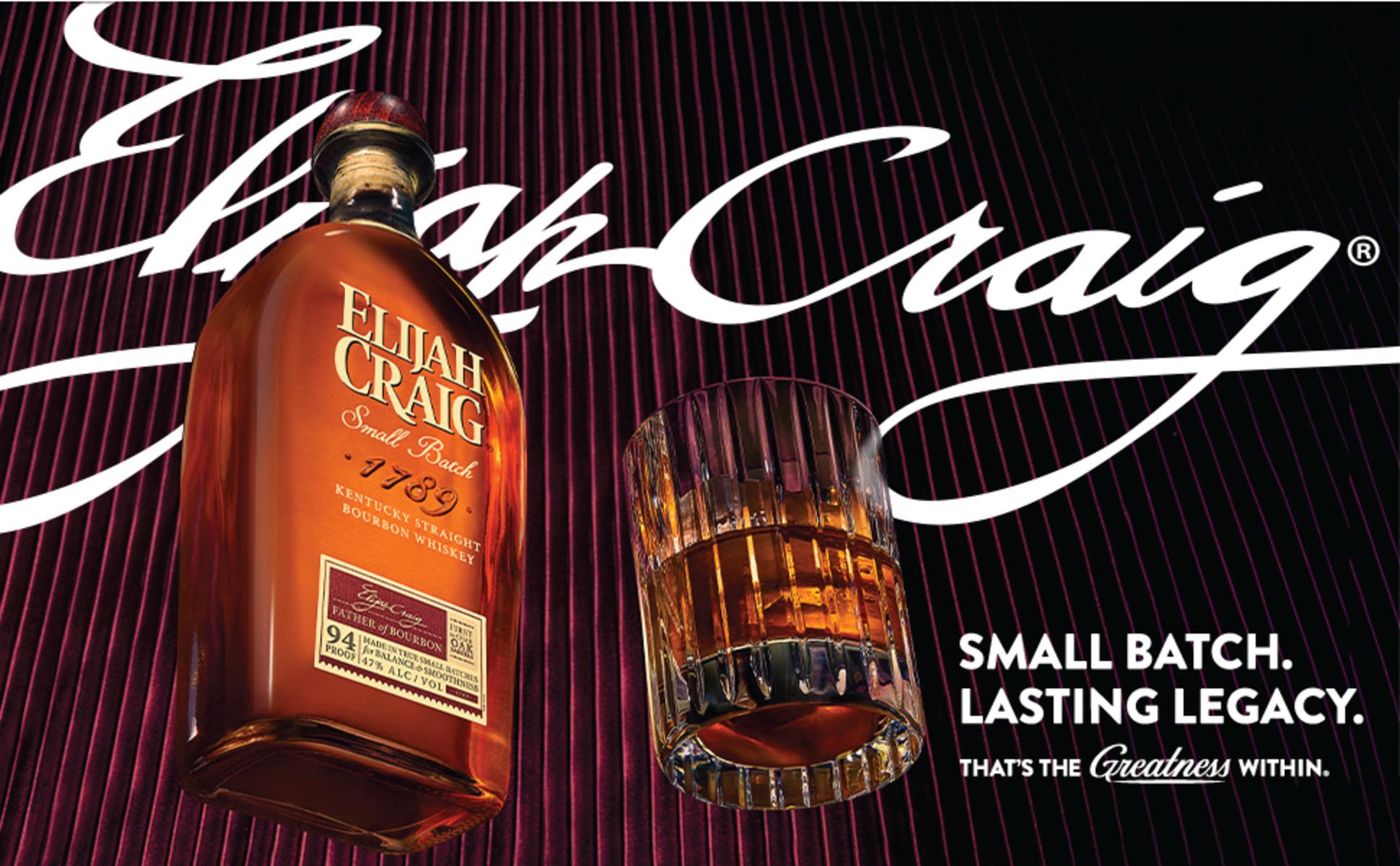 Maroon and black curtain background with Elijah Craig Small Batch and rocks glass.