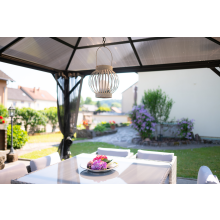 dinner table under sunlit gazebo