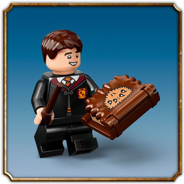 Place the mini The Monster Book of Monsters in his hand.