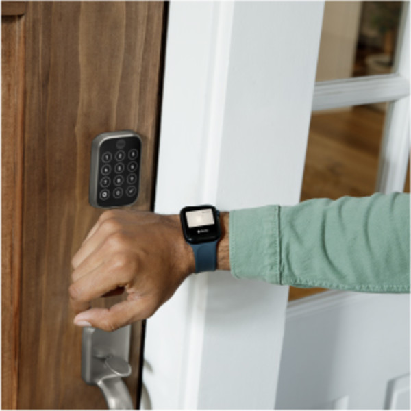 Man unlocking door lock with key