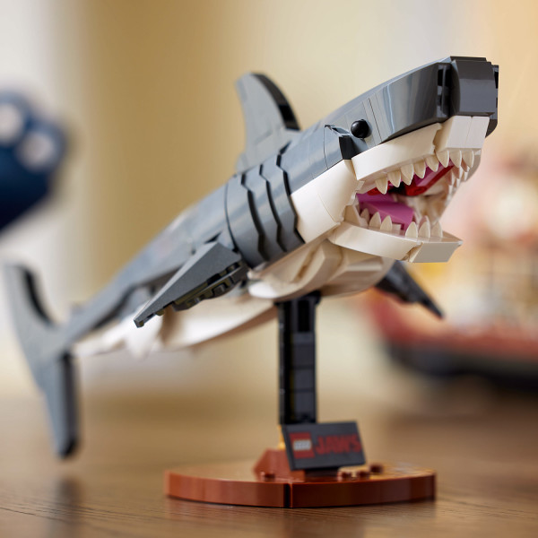 Showcase the shark and minifigures on the stand.