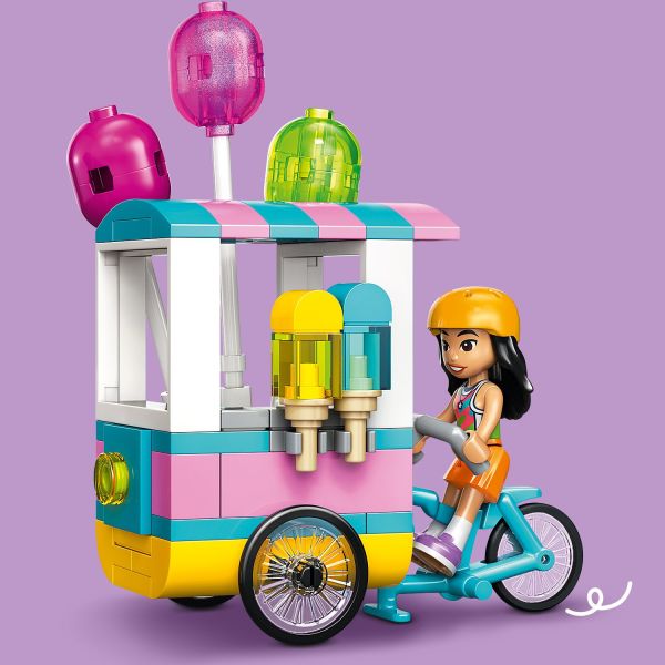 Liann rides the bike, which features a built-in food stand.