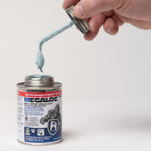 Megaloc Thread Sealant can opened with brush in lid exposed held by a hand