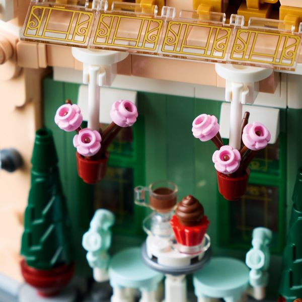 The picturesque facade is decorated with hanging flowerpots.