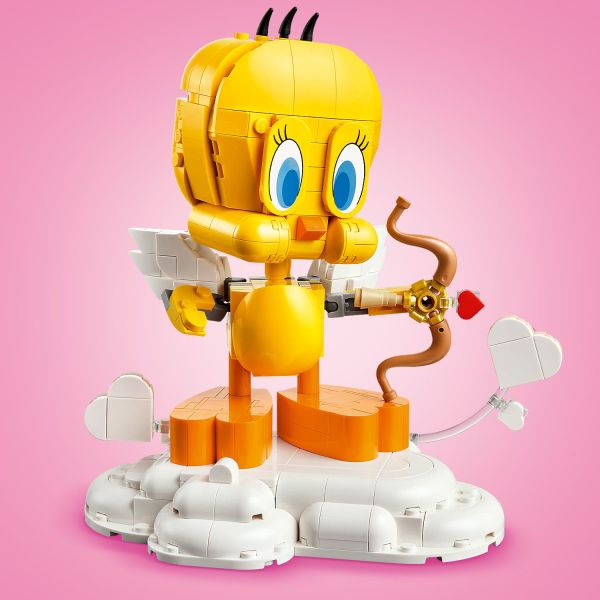 Pose Tweety with a bow and arrow on a cloud pedestal.